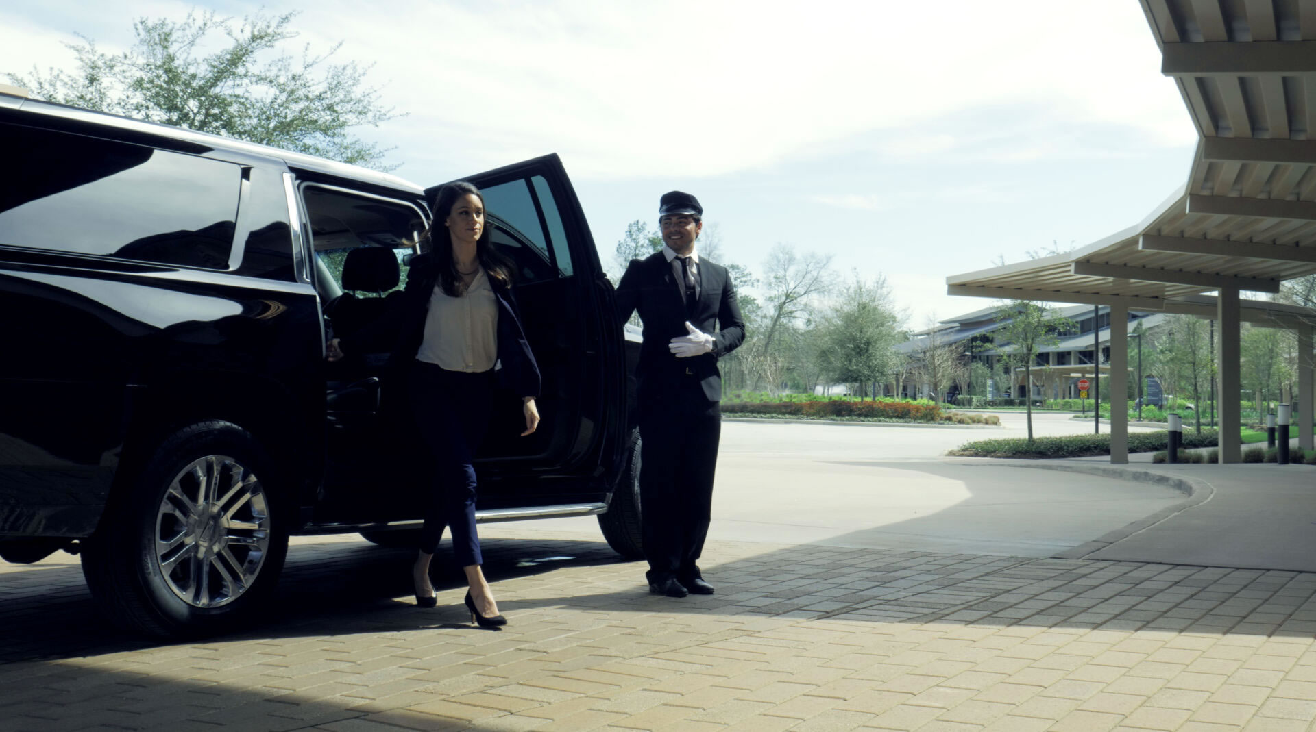 girl walking out of black luxury car