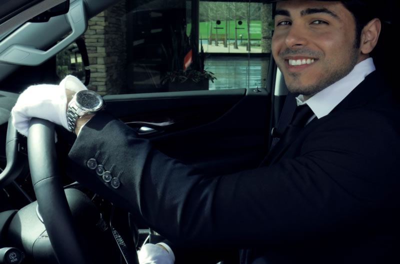 male chauffeur sitting inside a car